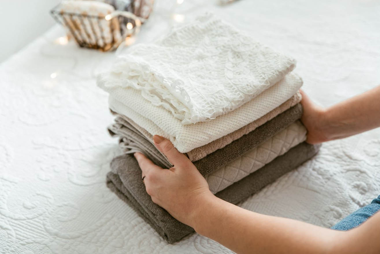 Freshly folded linens being prepared for a vacation-rental stay